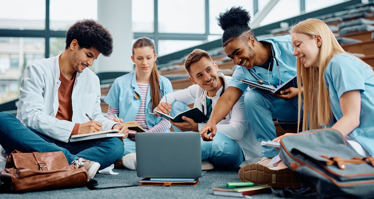 Group of happy medical students using laptop