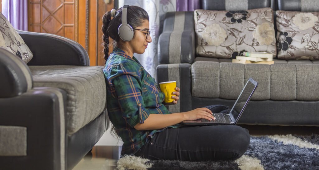 girl using laptop, sitting on floor