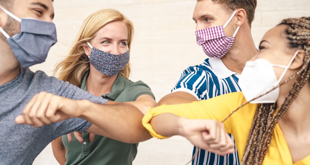 Students post pandemic greeting by touching elbows