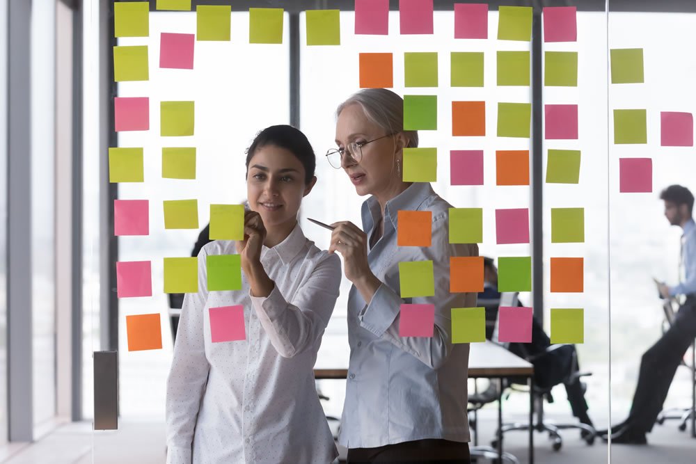 student and tutor looking at post it notes